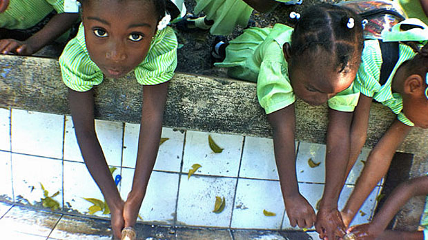 Haitian children washing hands to prevent cholera